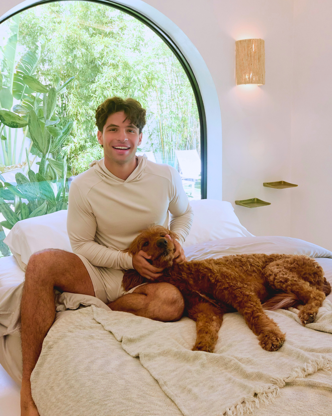 Man with dog sitting on bed with Faceplant's Ultra-Soft Plush Bamboo Throw